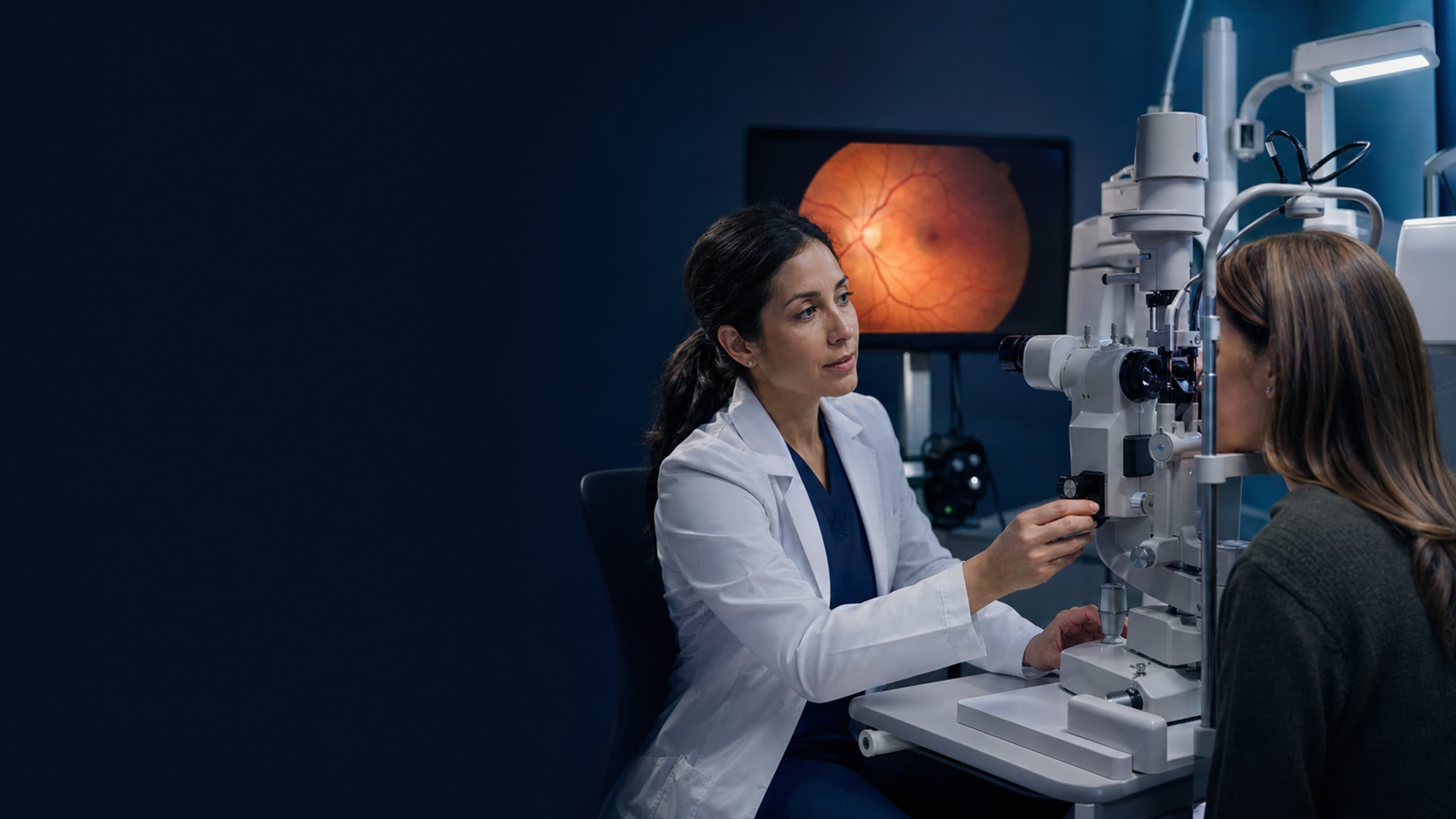Clinician using slit-lamp equipment during an eye examination