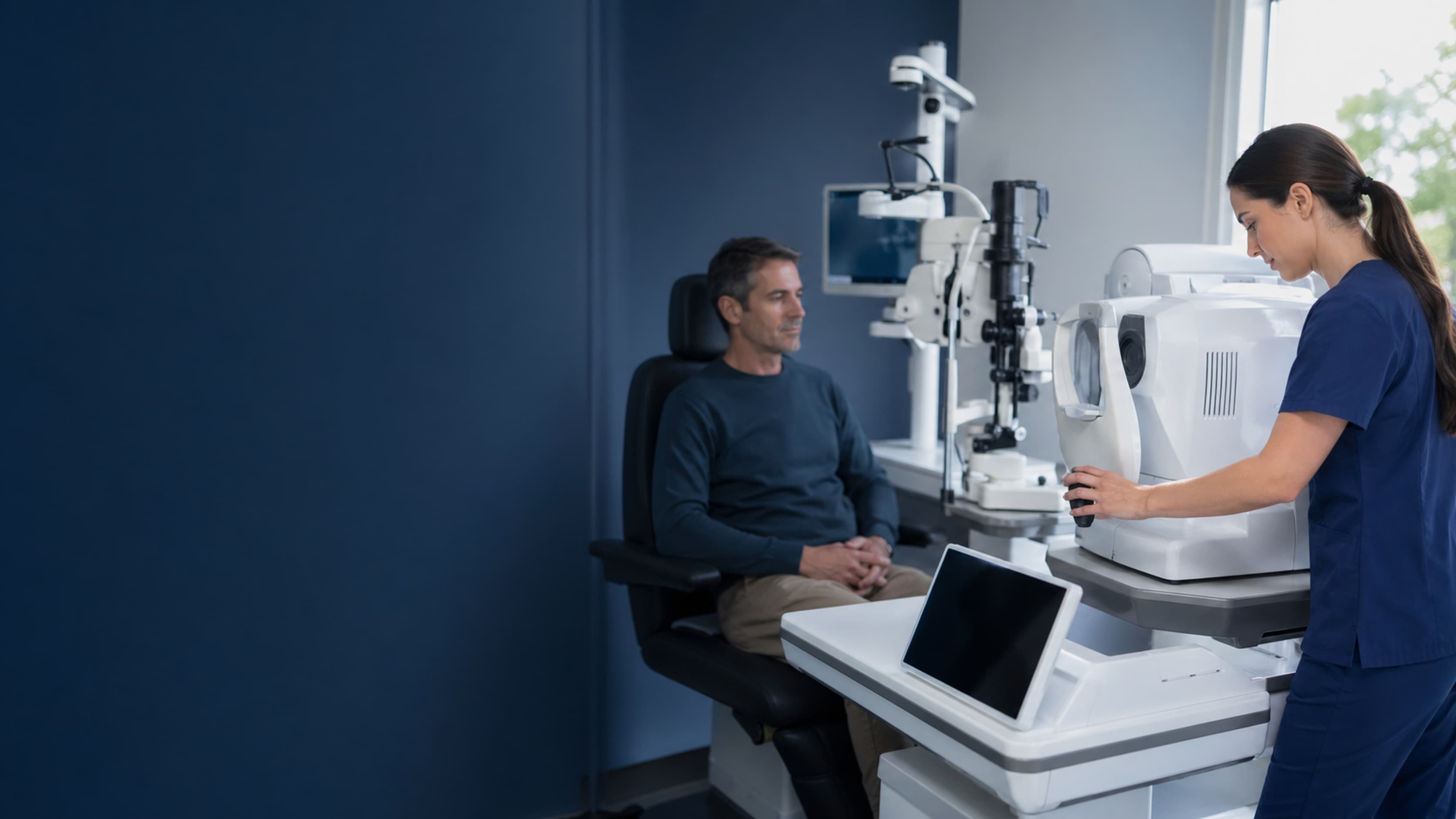Ophthalmic technician preparing diagnostic eye testing equipment